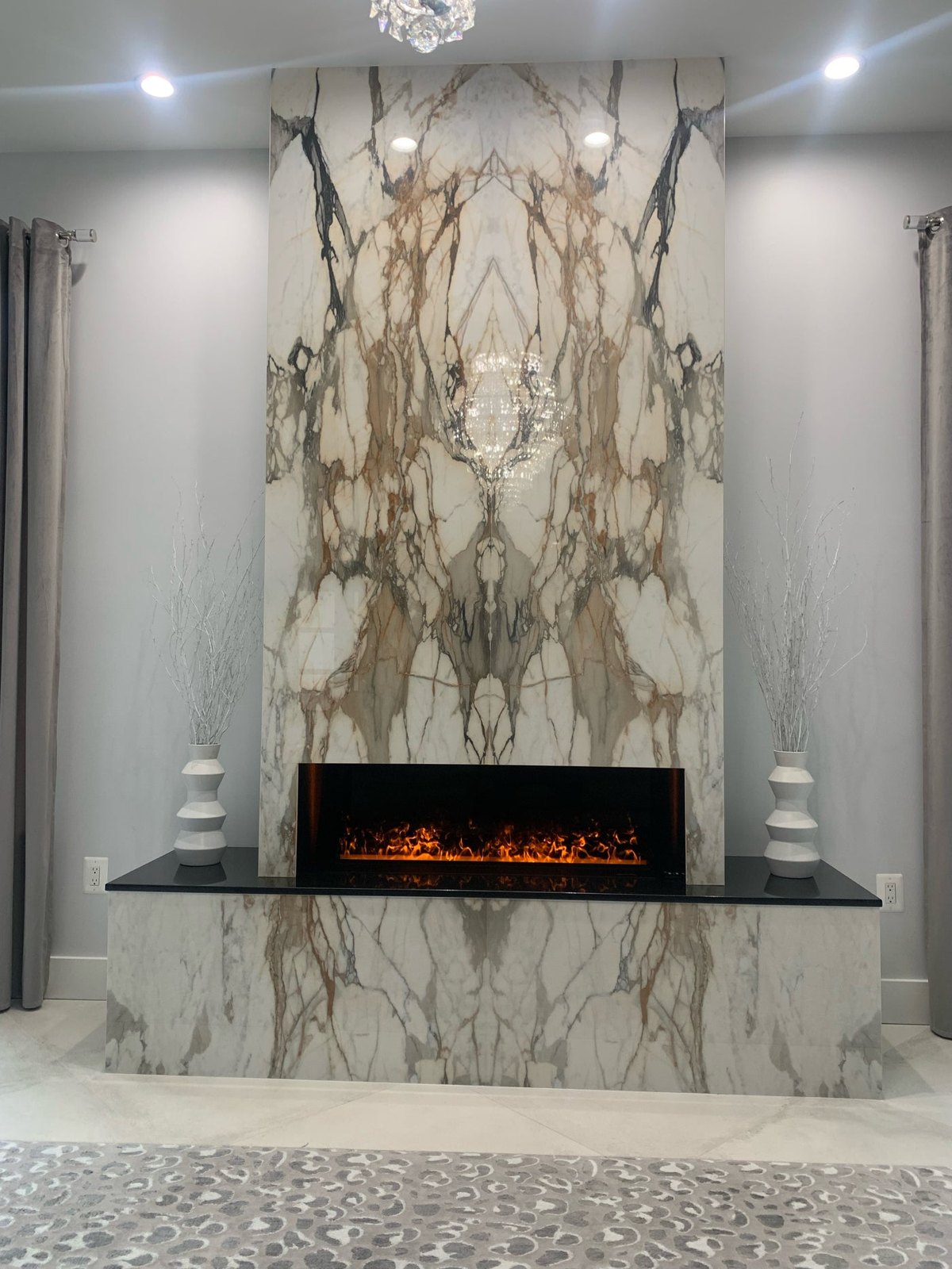 Aqua Fire set into a floor-to-ceiling marble feature wall